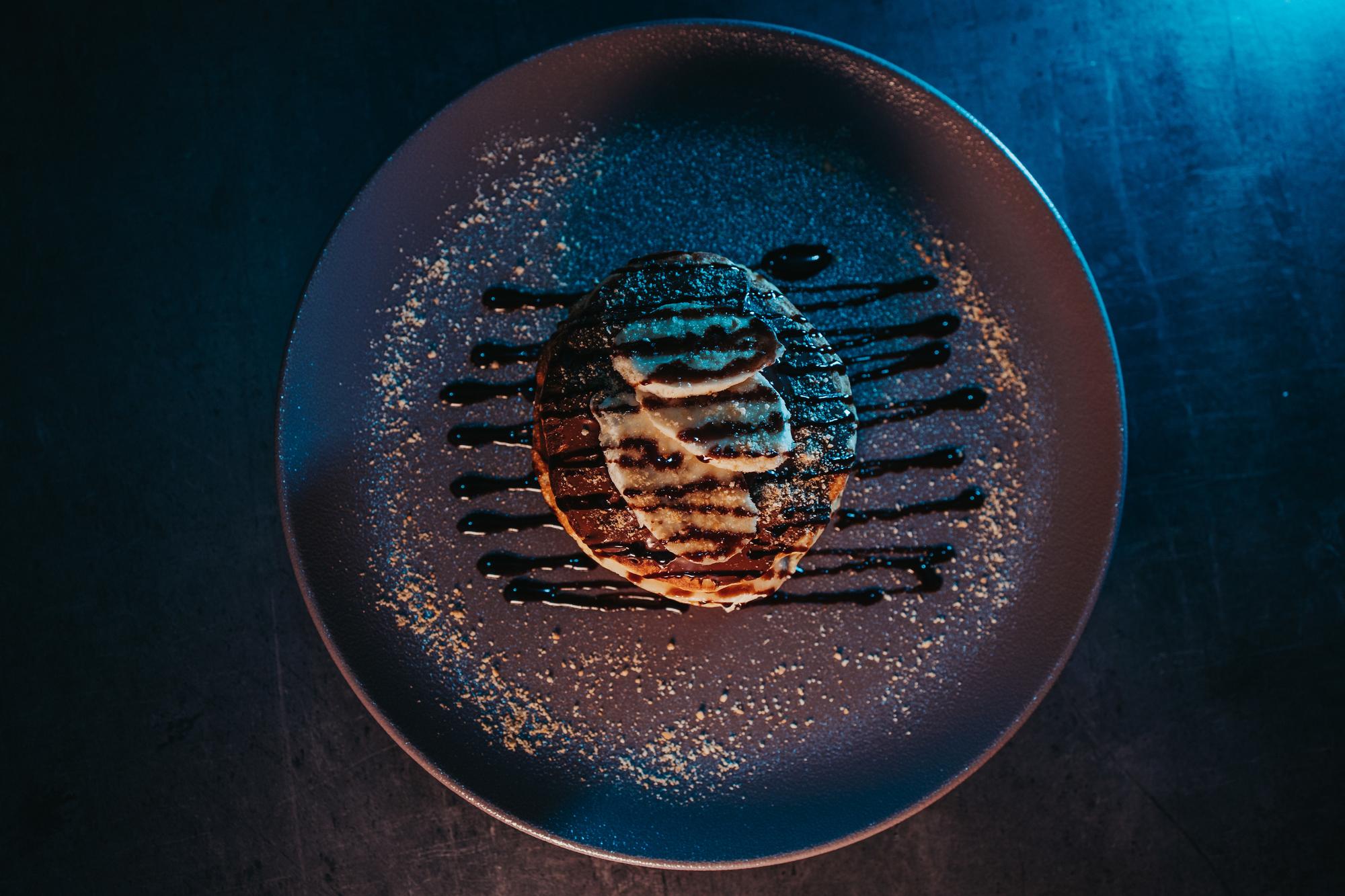 Close-up of modern plating on black plate