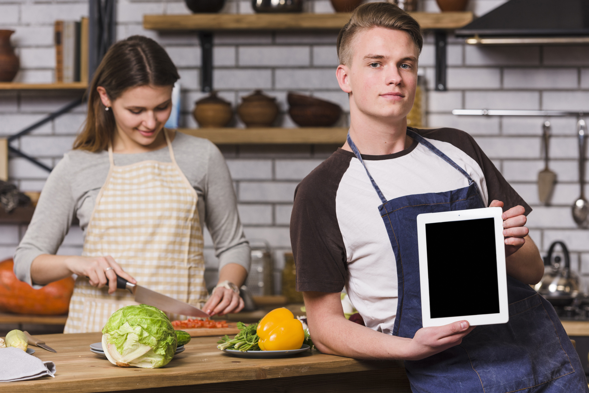 Students working with digital recipe tablet